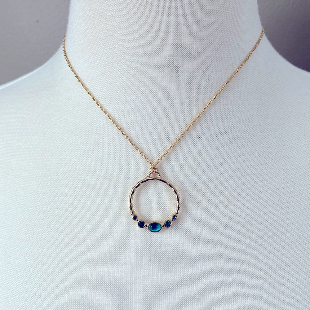 Avon gold tone open circle necklace with blue stones